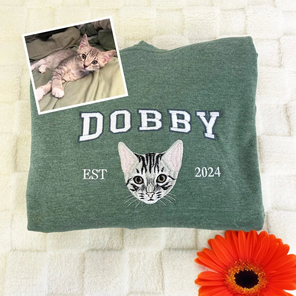 Heather green sweatshirt with DOBBY above an embroidered kitten face, shown with the original photo