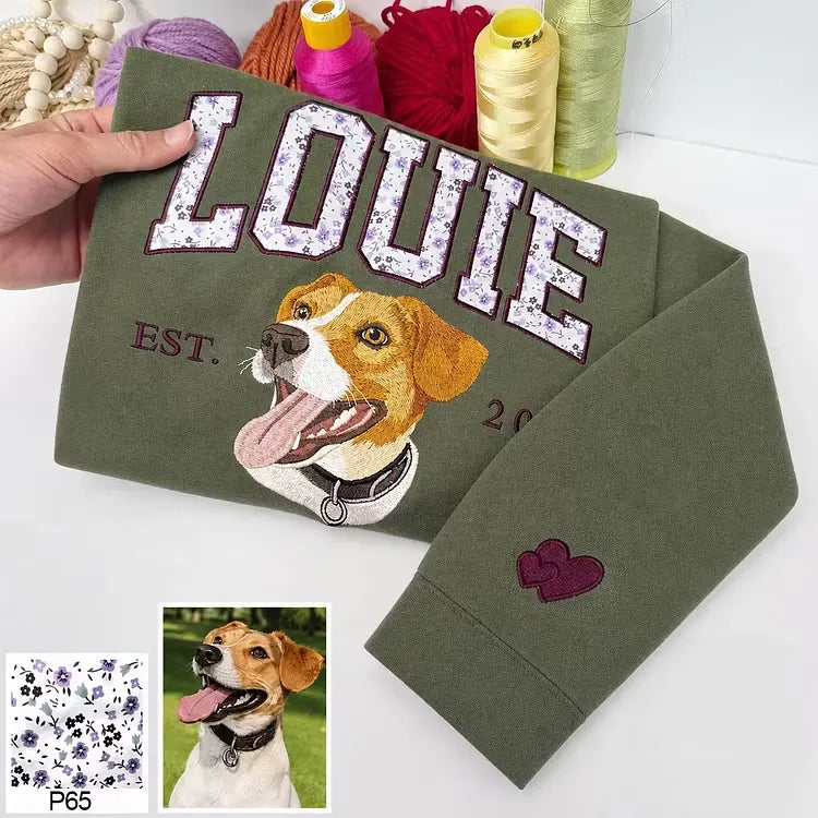 Green sweatshirt with LOUIE in floral appliqué letters, an embroidered beagle and a heart on the cuff