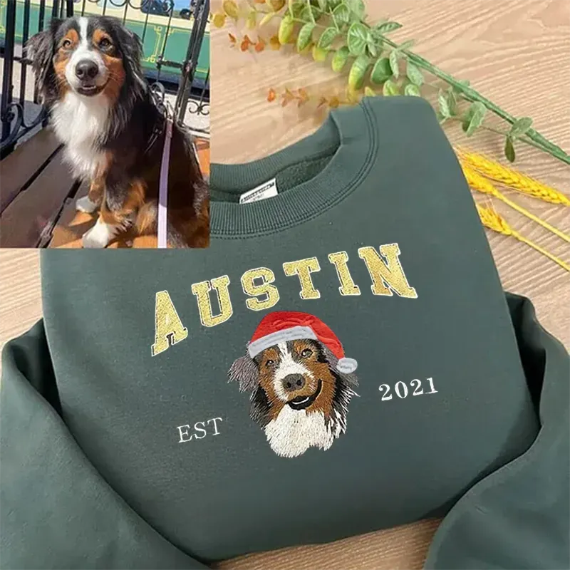 Forest green sweatshirt with AUSTIN in gold letters and an Australian shepherd wearing a Santa hat