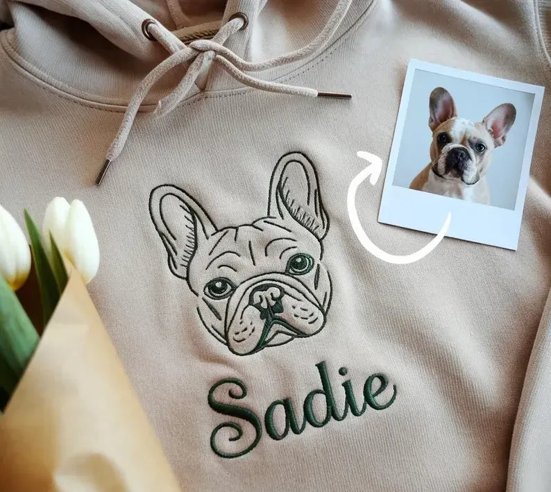 Sand hoodie with a French bulldog outline portrait and the name Sadie in dark green script, shown with the original photo