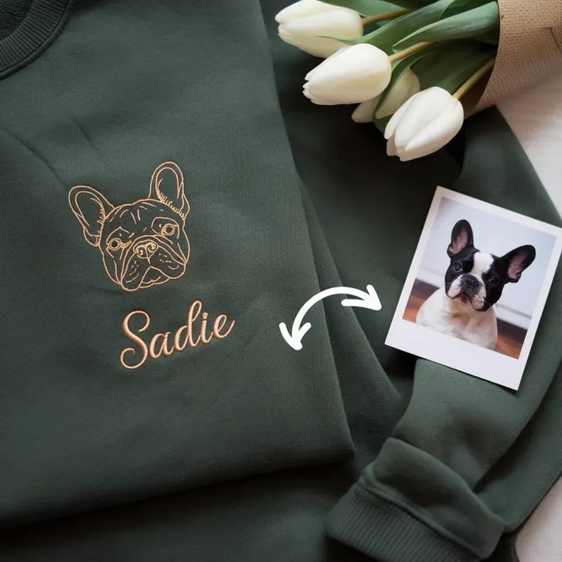 Left chest gold outline French bulldog with the name Sadie on a dark green sweatshirt
