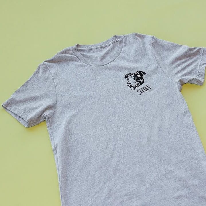Heather gray tee with a black line art dog portrait and the name Captain