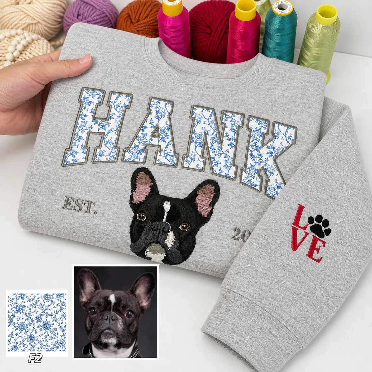 Gray sweatshirt with HANK in blue floral appliqué letters, an embroidered French bulldog and LOVE on the sleeve