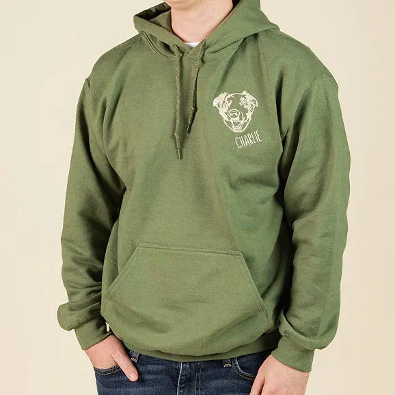 Man in a green hoodie with a white embroidered dog outline and name on the chest