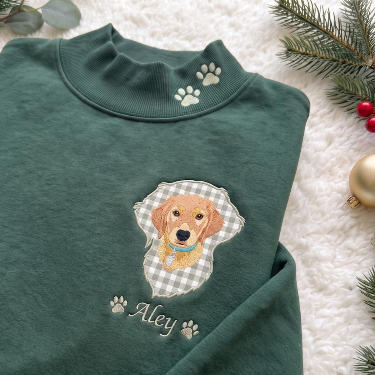 Close-up of green Aley mockneck with gingham pet portrait applique