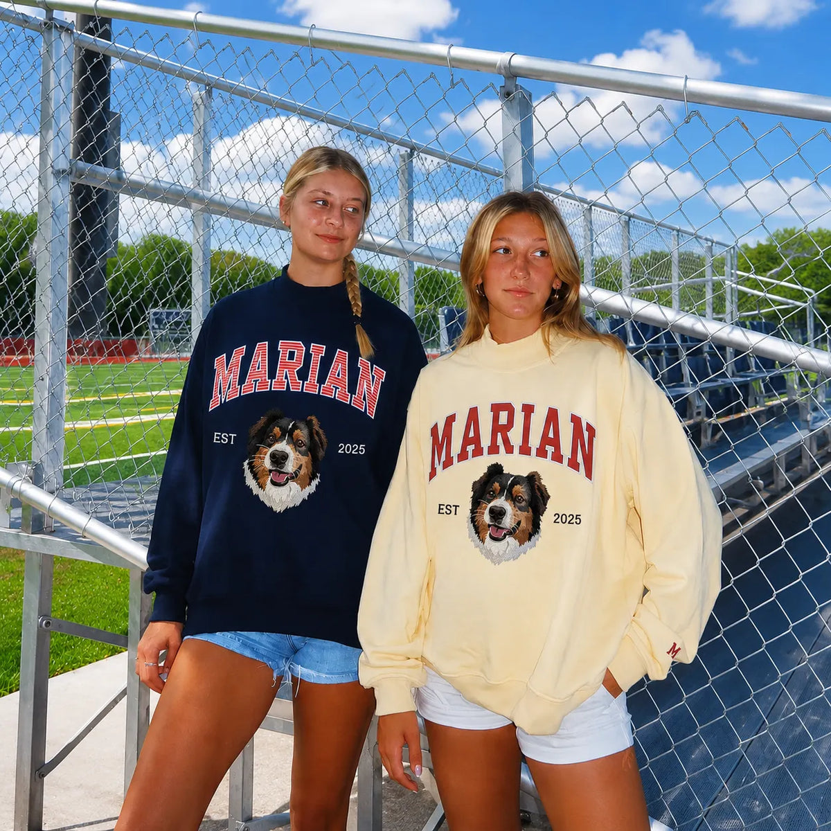 Two friends in navy and butter yellow mockneck sweatshirts with MARIAN and an embroidered Bernese mountain dog