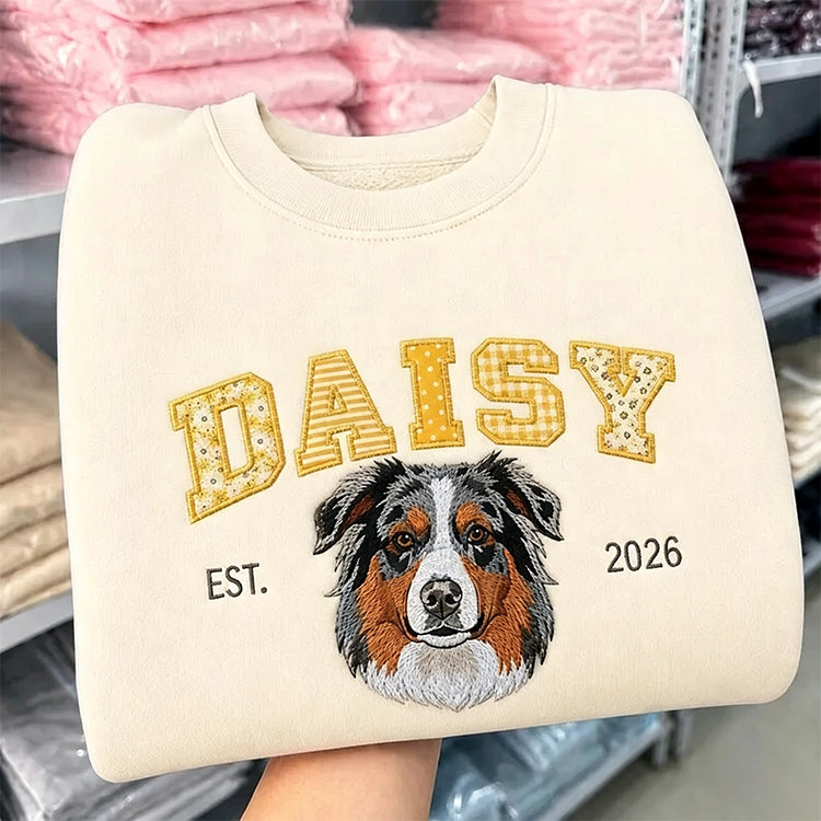 Cream sweatshirt with DAISY in yellow patchwork letters above an embroidered Australian shepherd