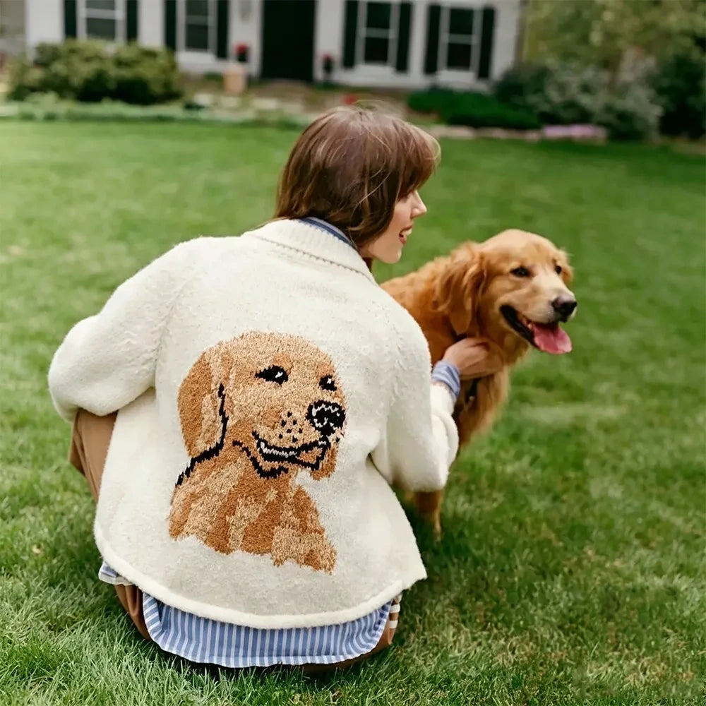 Woman sitting on the lawn with her golden retriever, wearing an ivory cardigan with the dog's portrait knitted on the back