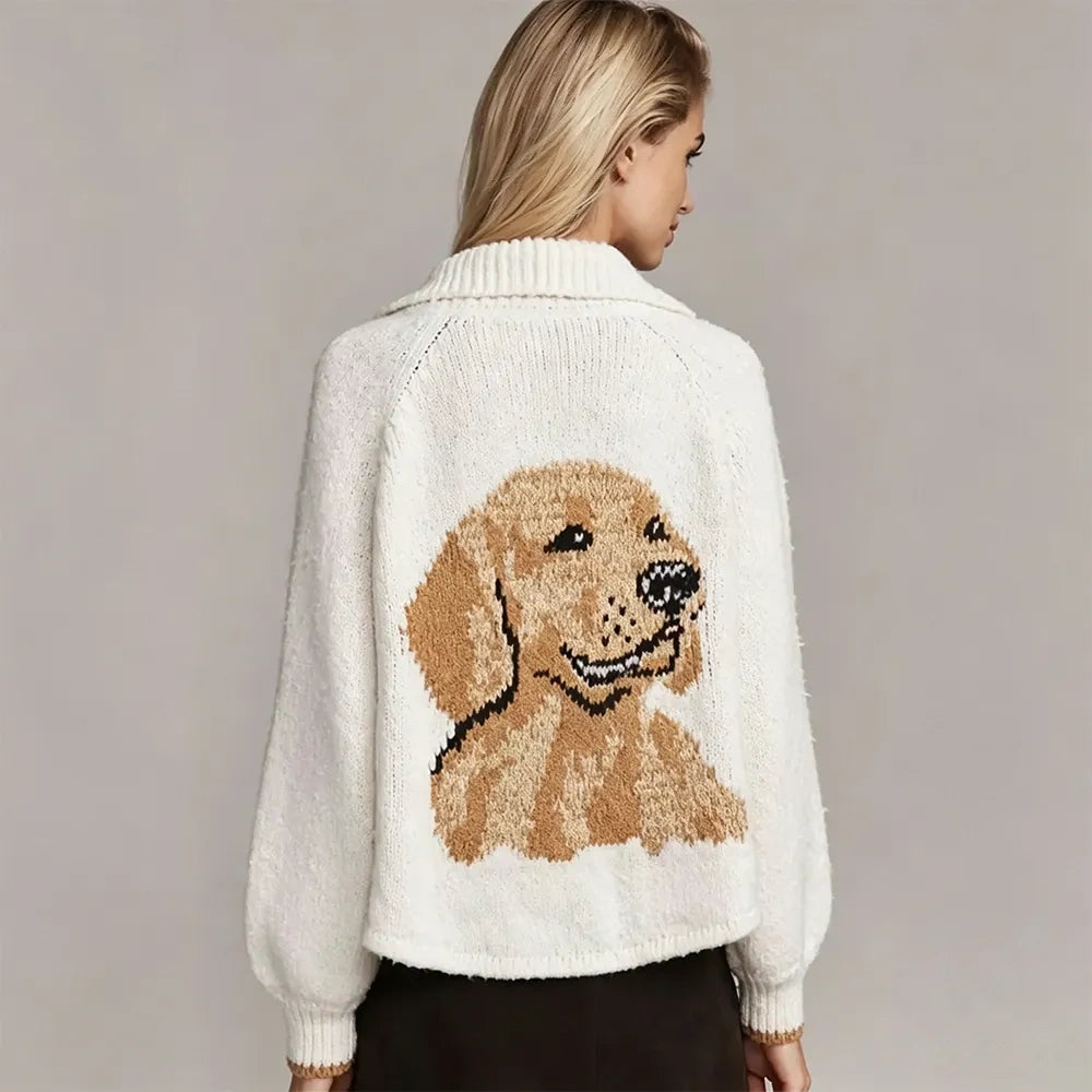Back of an ivory cardigan with a knitted golden retriever portrait, worn by a model