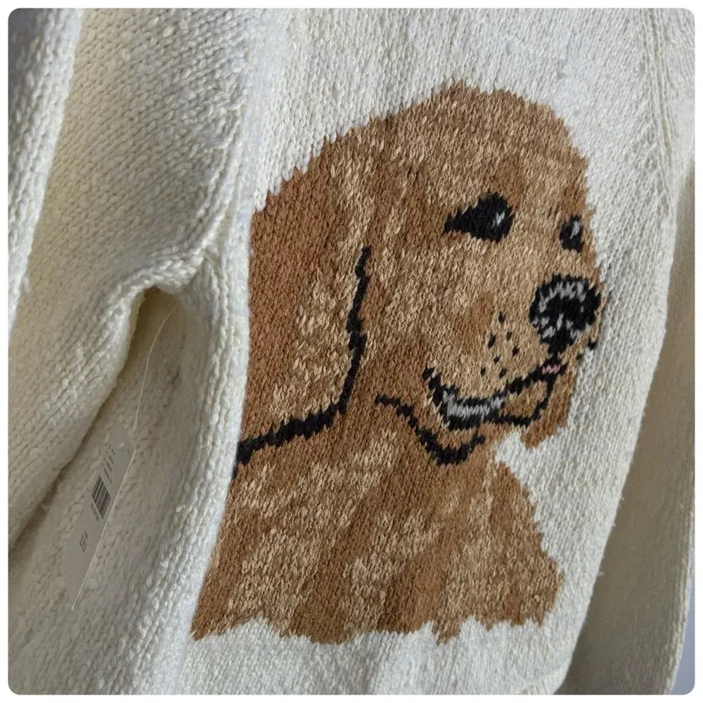 Close-up of a knitted golden retriever portrait on an ivory cardigan