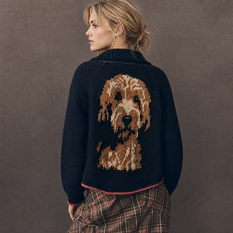 Model turning to show a navy cardigan with a doodle portrait knitted on the back