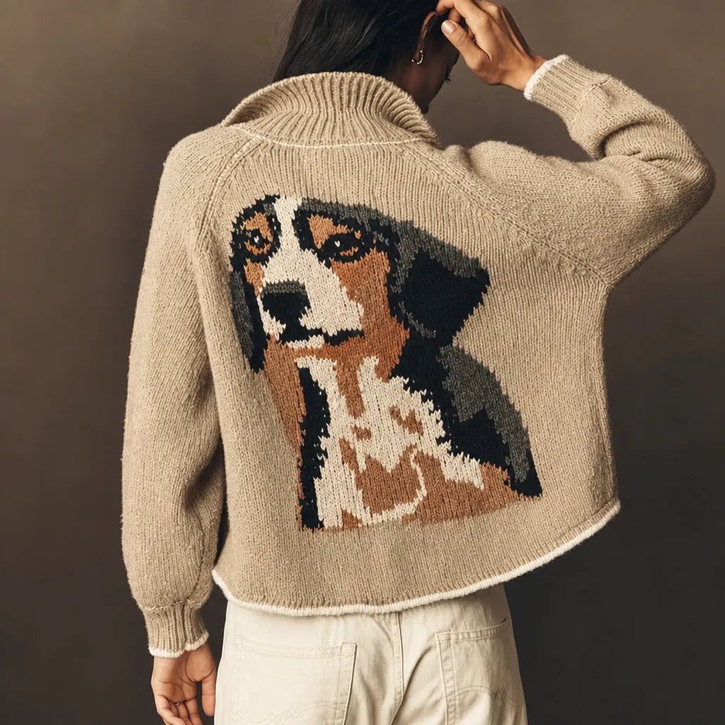 Woman in a beige cardigan with her beagle's portrait knitted on the back