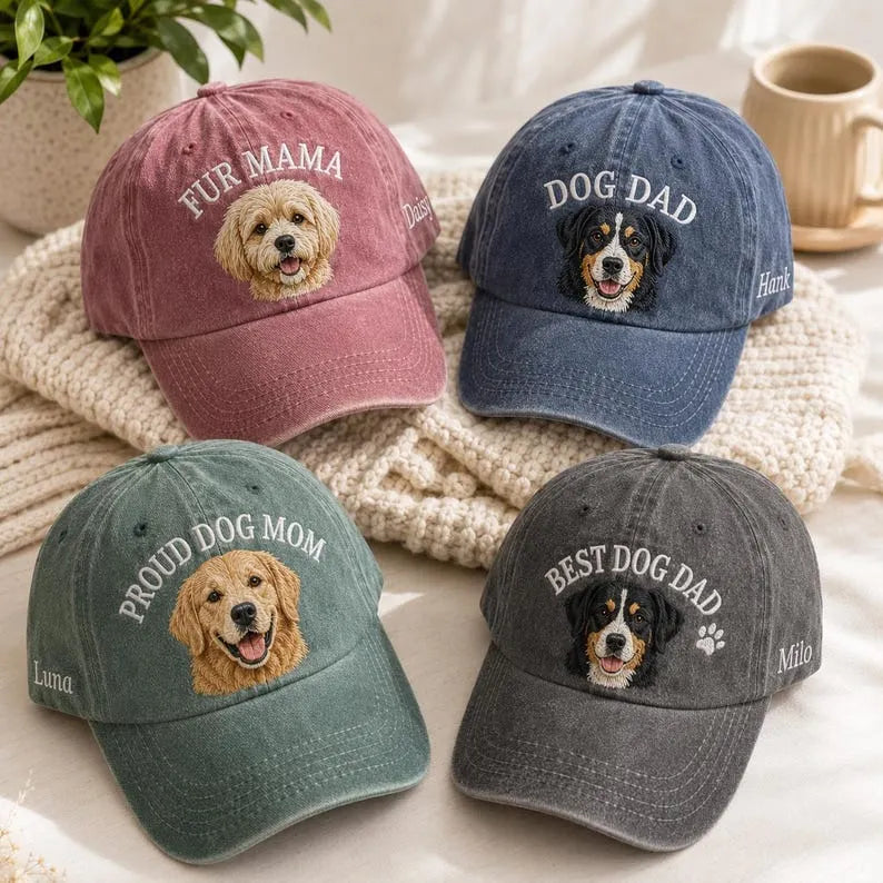 Four washed caps: pink FUR MAMA, navy DOG DAD, green PROUD DOG MOM and charcoal BEST DOG DAD with embroidered dog faces