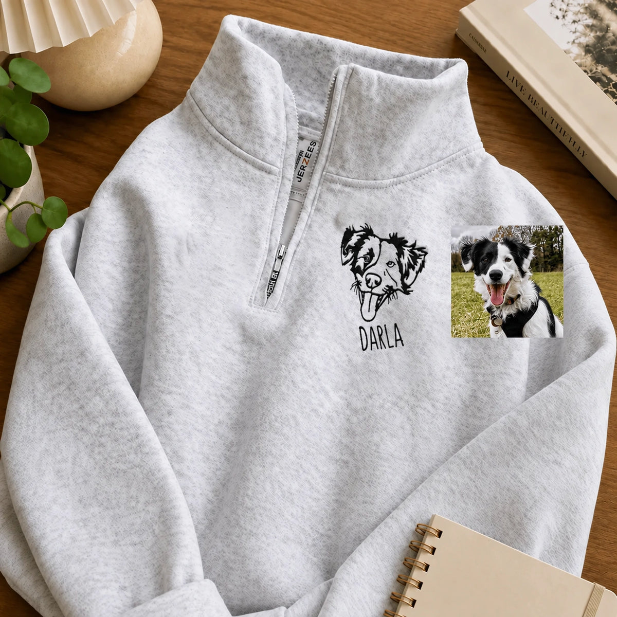 Heather gray quarter zip sweatshirt with a line art border collie named DARLA beside the pet photo